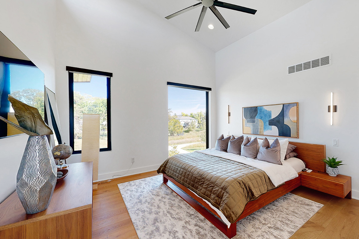 HDR photo of bedroom with high ceilings and a rug