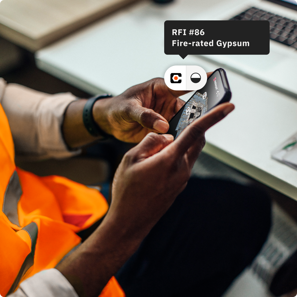 A construction worker looking at a Matterport model on his phone