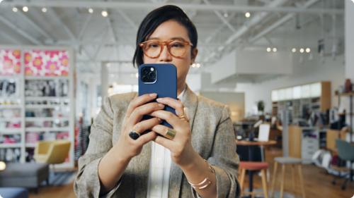 A woman holding up a smart phone